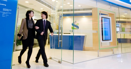 Standard Chartered Reports Lower Profit